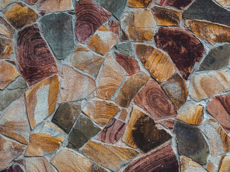 texture of an old stone wall made of natural multi-colored slabsの写真素材