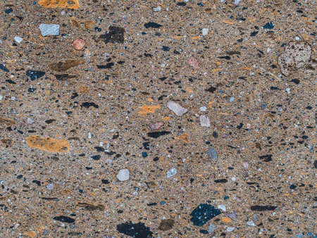brown decorative coating of the facade of a building with many stonesの写真素材