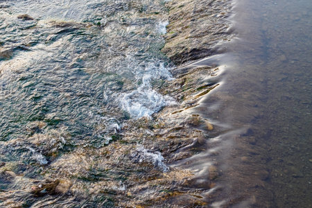 river rapid in the city at sunsetの写真素材