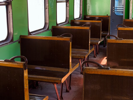seats inside an old train carriageの写真素材