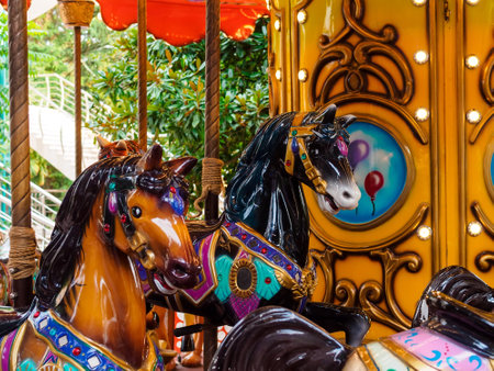 Horses on a carousel in the parkの写真素材