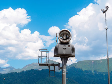 Fan snow gun in the mountains in sunny weatherの写真素材