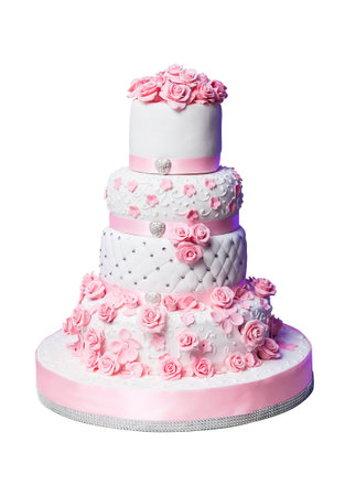 beautiful white wedding cake decorated with pink ribbons and flowers. Isolated on whiteの写真素材