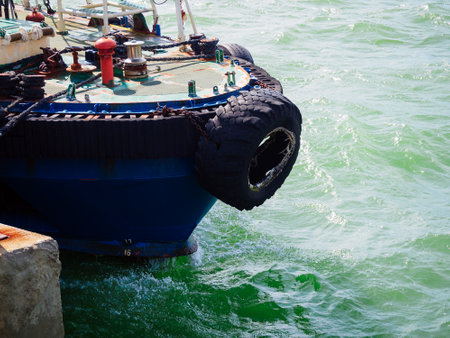 old car tire on the bow of a ship in the portの写真素材