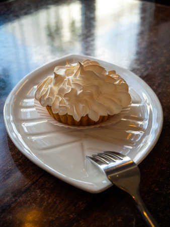 lemon tartlet with meringue on a plate close-upの写真素材