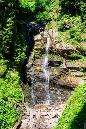 Waterfall high in the mountains in summerの写真素材