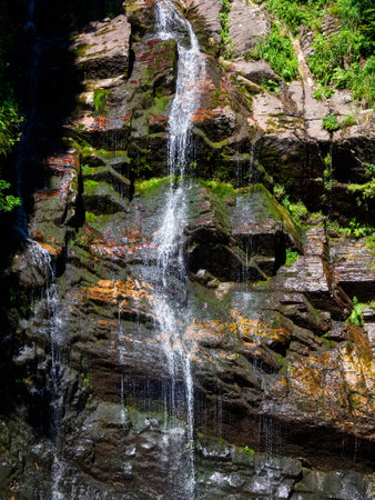 Thin streams of waterfall on the rocksの写真素材