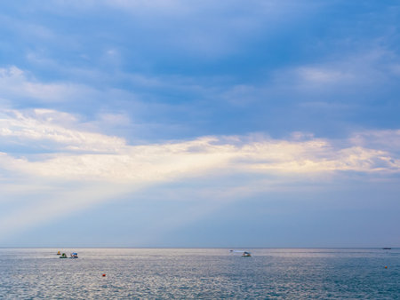 clouds, beautiful rays of light over the sea in summerの写真素材