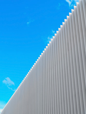 white lines in detail against the background of a building and abstract architecture against the background of a blue skyの写真素材