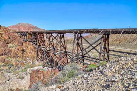 Nivloc, Nevada - May 2020: An abandoned wooden ore cart trestle is amongst the remains of the mining ghost town of Nivloc.のeditorial素材