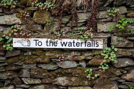 Sign pointing to the waterfalls in the lake district national parkの写真素材