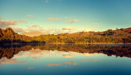 view of lakes with mountains and relection at sunsetの写真素材
