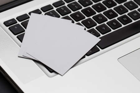 Business cards spread on a computer keybaordの写真素材