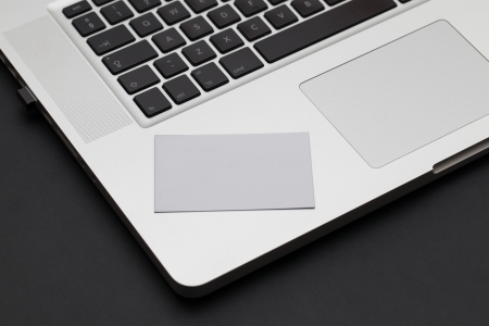 Business card on a laptop keyboardの写真素材