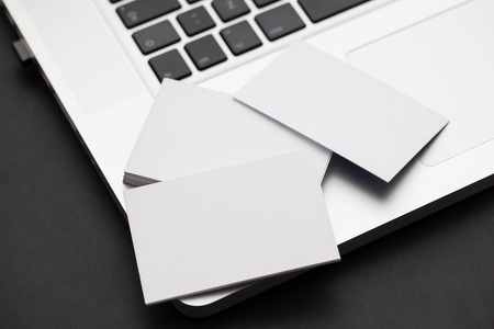 Business card piled ona  computerの写真素材