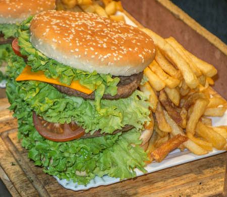 very large cheese burger and chipsの写真素材