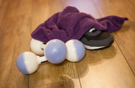 Dumbbells towel and trainer after workoutの写真素材