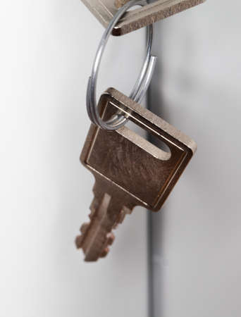 Key in a filing cabinet with white background,の写真素材