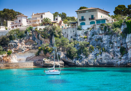 Porto Cristo , Majroca, Spain - April 24, 2014  A single yacht harboured near the cliffsのeditorial素材