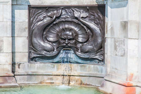 Ornate fountain with water flowing from mouthの写真素材