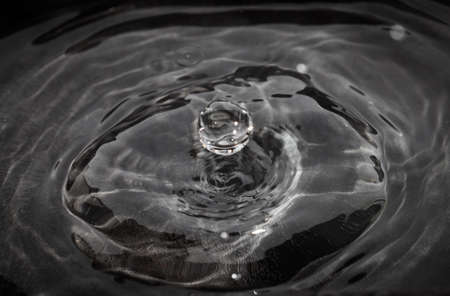 Close up of drop of water splashing in poolの写真素材