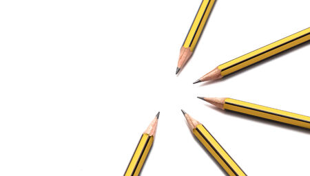 Pencils together forming pattern on white paper の写真素材