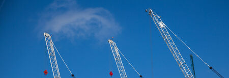 Tall cranes building background conceptの写真素材