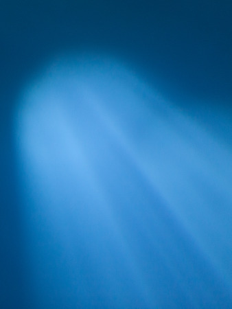 Sunbeam through water in the oceanの写真素材