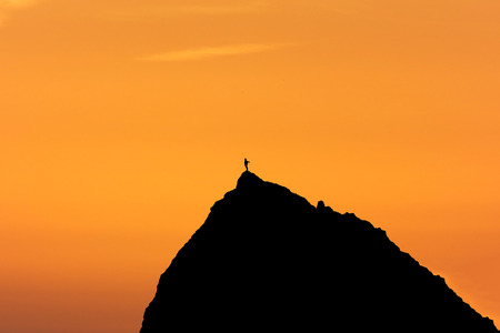 silhouette showing success with sky backgroundの写真素材