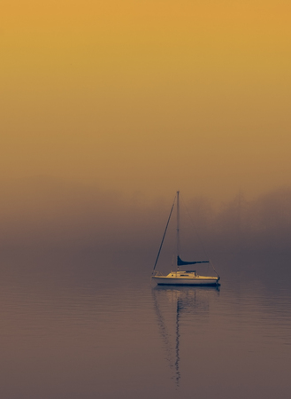 Boat on  a foggy Lake windermereの写真素材