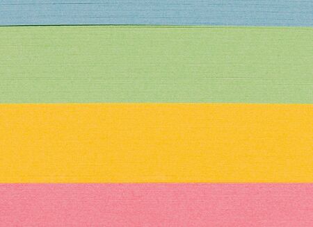 Stack ofcoloured paper shot in macro to make abstract background