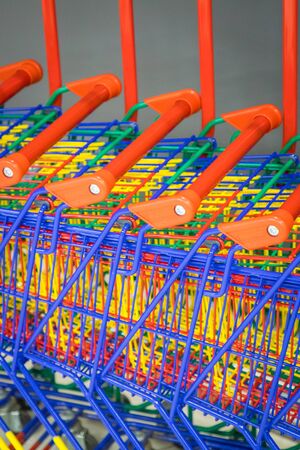 many shopping colorful shopping trolleys togetherの写真素材