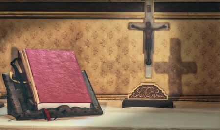 Cross and bible on an altar insideの写真素材