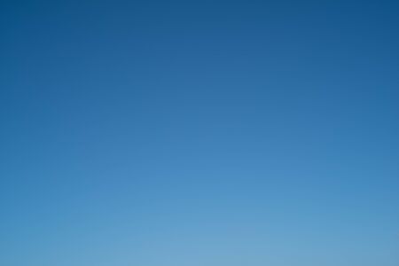 plain blue sky backgroundの写真素材