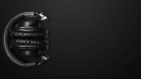 Black background with musical headphones. Headphones for music