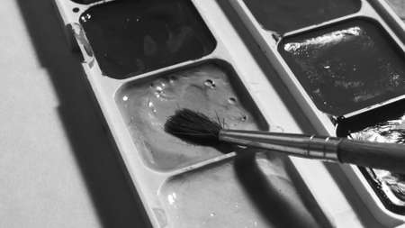 The brush is dipped in yellow paint. Macro photography.の写真素材