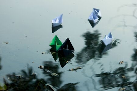 Paper boats floating on water