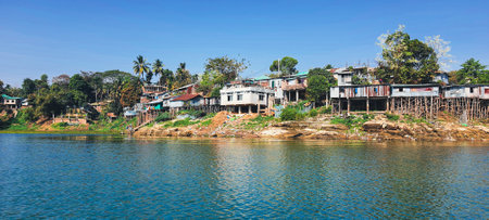 Rural house on silts hill tribe settlements along the coastline of Kaptai lakeの写真素材