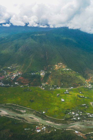 Tranquil scenic countryside vegetation and houses in Druk Bhutanの写真素材