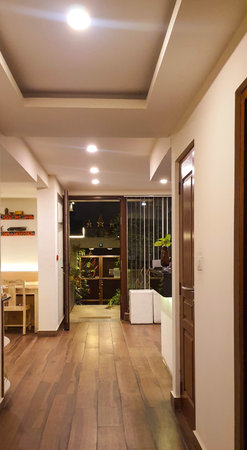 Modern Interior Hallway with Warm Lighting and Open Garden Viewの写真素材