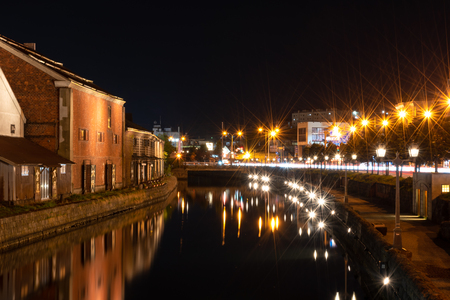 Landscape view of Otaru canals and warehouse at night in Hokkaido Japan. Here is a famous landmark of Otaru city. Text in Japanese is Otaru storehouse.のeditorial素材
