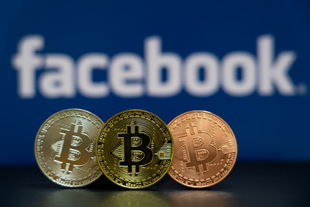 Bitcoin coin with the Facebook logo screen backgroundのeditorial素材