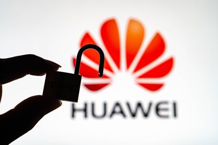 Huawei logo in background with silhouette of a unlock padlock.のeditorial素材