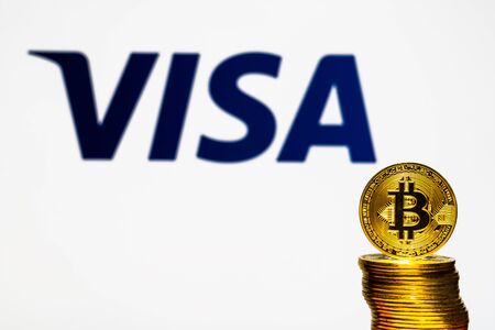 Gold Bitcoin coins with the Visa Plus System logo on background screen. A new type of business finance conceptのeditorial素材