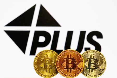 Gold Bitcoin coins with the Visa Plus System logo on background screen. A new type of business finance conceptのeditorial素材