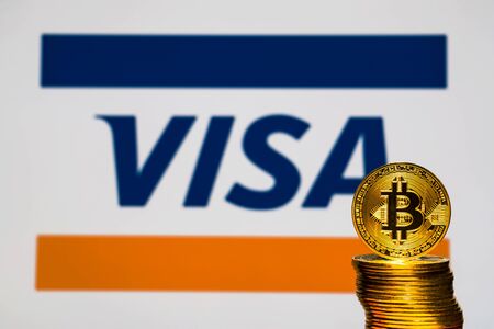 Gold Bitcoin coins with the Visa Plus System logo on background screen. A new type of business finance conceptのeditorial素材