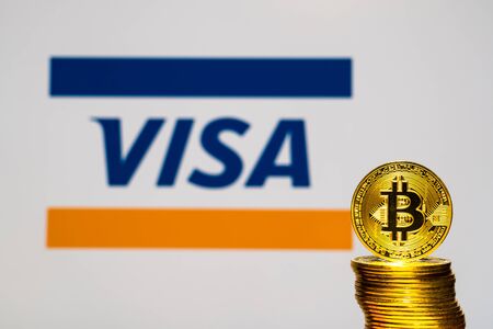 Gold Bitcoin coins with the Visa Plus System logo on background screen. A new type of business finance conceptのeditorial素材