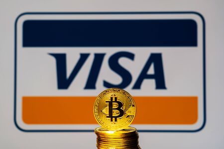Gold Bitcoin coins with the Visa Plus System logo on background screen. A new type of business finance conceptのeditorial素材