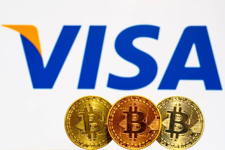 Gold Bitcoin coins with the Visa Plus System logo on background screen. A new type of business finance conceptのeditorial素材