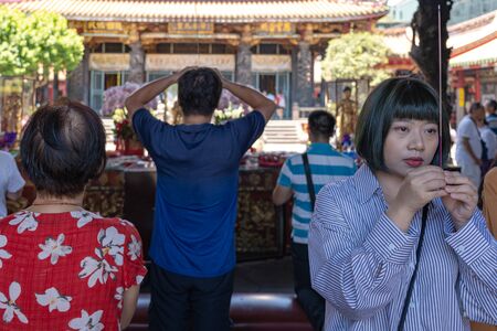 Believers pious worship in the Bangka Longshan Temple. Is a Chinese folk religious temple in Wanhua District.のeditorial素材